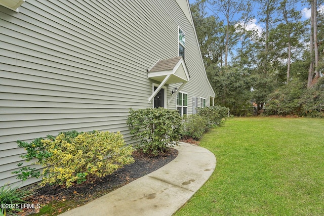 view of home's exterior with a lawn