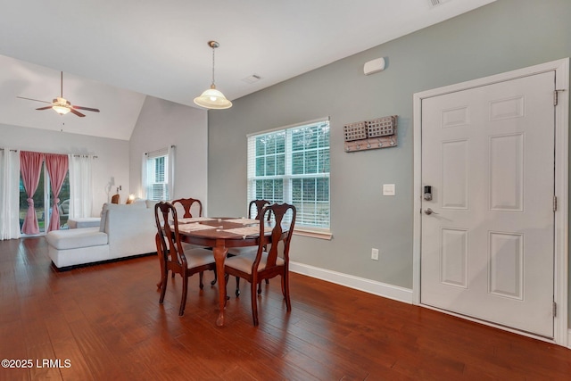 dining room featuring dark wood-type flooring, ceiling fan, and vaulted ceiling