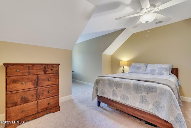 carpeted bedroom with vaulted ceiling and ceiling fan