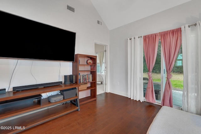 living room featuring high vaulted ceiling and dark hardwood / wood-style flooring