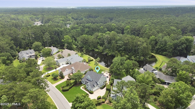 4 Halburton Cir, Bluffton, SC 29910 - aerial view of property and surrounding area featuring a heavily wooded area, nearby suburban area, and a nearby body of water