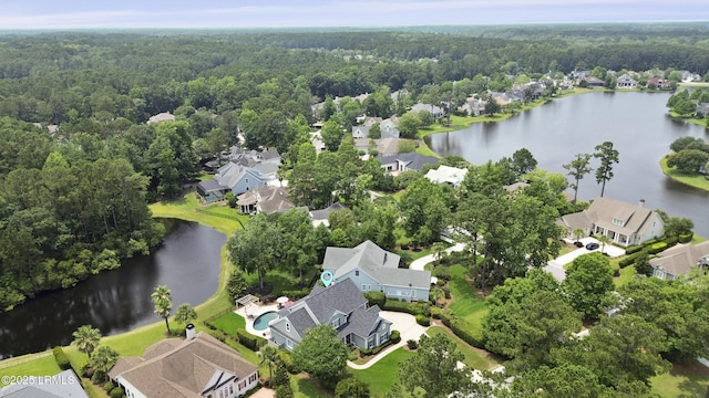4 Halburton Cir, Bluffton, SC 29910 - aerial view of property and surrounding area featuring a heavily wooded area, a large body of water, and nearby suburban area
