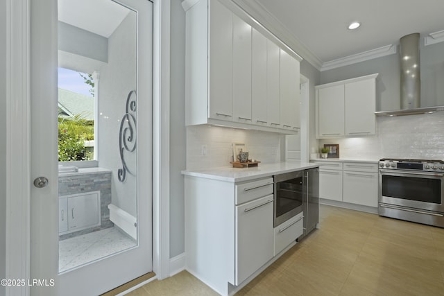 4 Halburton Cir, Bluffton, SC 29910 - kitchen featuring appliances with stainless steel finishes, wall chimney range hood, decorative backsplash, light countertops, and white cabinetry