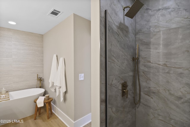 11 Lake Forest Dr Unit 3360, Hilton Head Island, SC 29928 - bathroom with a freestanding tub, a tile shower, wood finished floors, and recessed lighting
