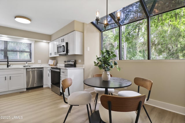 11 Lake Forest Dr Unit 3360, Hilton Head Island, SC 29928 - kitchen featuring stainless steel appliances, light countertops, light wood-style flooring, and white cabinetry
