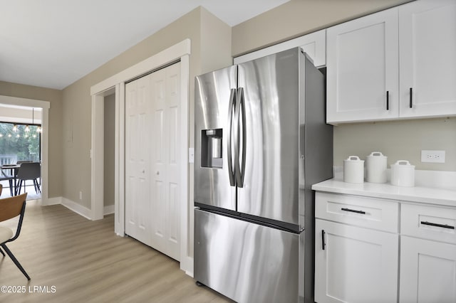 11 Lake Forest Dr Unit 3360, Hilton Head Island, SC 29928 - kitchen with stainless steel fridge, white cabinetry, light wood-style floors, and light countertops