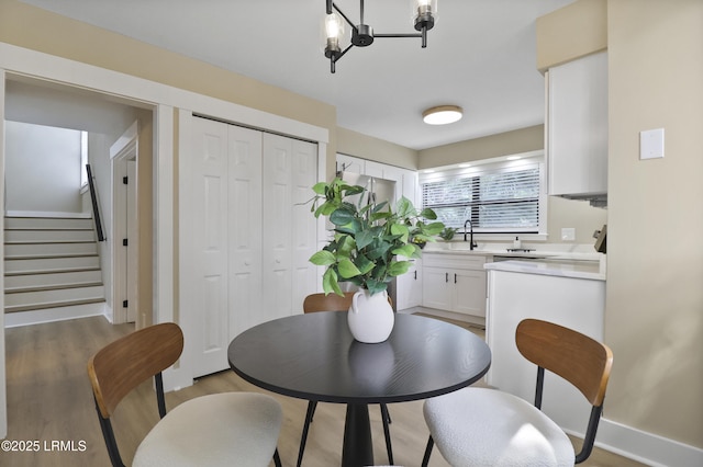 11 Lake Forest Dr Unit 3360, Hilton Head Island, SC 29928 - dining area featuring stairs, light wood finished floors, and a chandelier