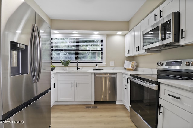 11 Lake Forest Dr Unit 3360, Hilton Head Island, SC 29928 - kitchen with stainless steel appliances, light wood-style flooring, white cabinetry, light countertops, and recessed lighting