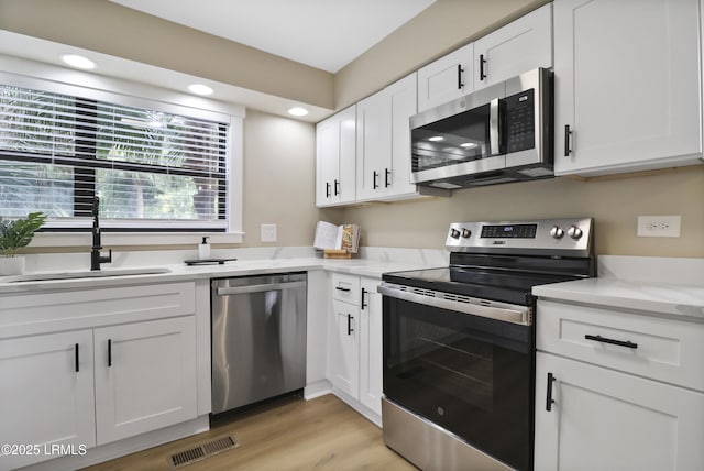 11 Lake Forest Dr Unit 3360, Hilton Head Island, SC 29928 - kitchen featuring appliances with stainless steel finishes, white cabinets, light wood-type flooring, and recessed lighting