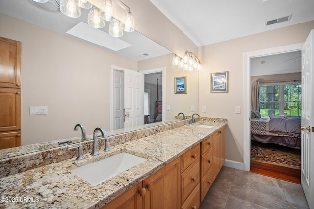 1716 Longfield Dr, Saint Helena Island, SC 29920 - full bathroom with connected bathroom, double vanity, a skylight, and baseboards