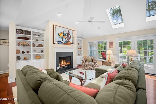 1716 Longfield Dr, Saint Helena Island, SC 29920 - living area featuring a fireplace with flush hearth, wood finished floors, built in features, ceiling fan, and a skylight