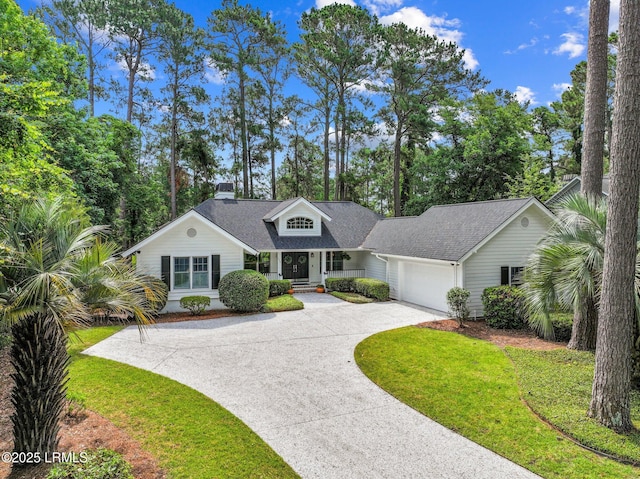 1716 Longfield Dr, Saint Helena Island, SC 29920 - view of front facade with driveway, a garage, a front lawn, roof with shingles, and a chimney