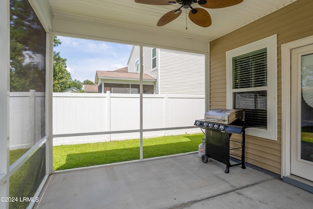 unfurnished sunroom featuring ceiling fan