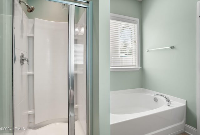 bathroom with separate shower and tub