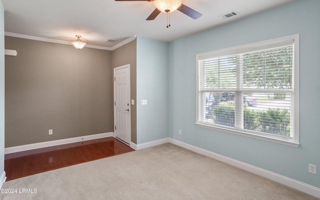 unfurnished room featuring carpet floors, ornamental molding, and ceiling fan