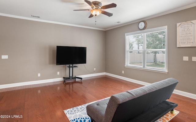 living room featuring hardwood / wood-style floors, crown molding, and ceiling fan