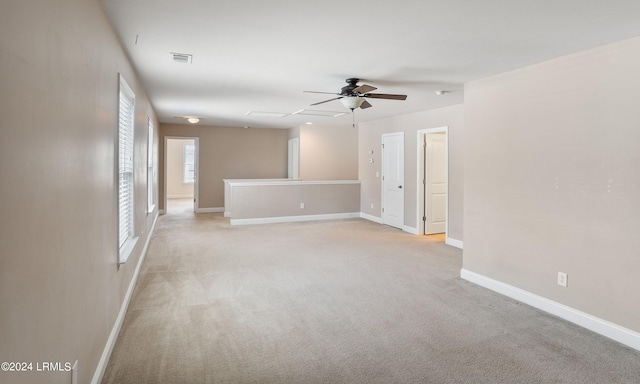 unfurnished room featuring light colored carpet and ceiling fan