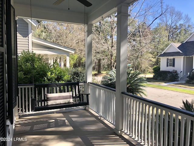 balcony featuring a porch and ceiling fan