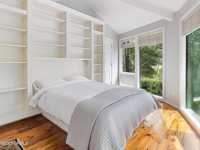 2065 Deer Island Rd, Hilton Head Island, SC 29928 - bedroom featuring wood finished floors, multiple windows, and access to exterior