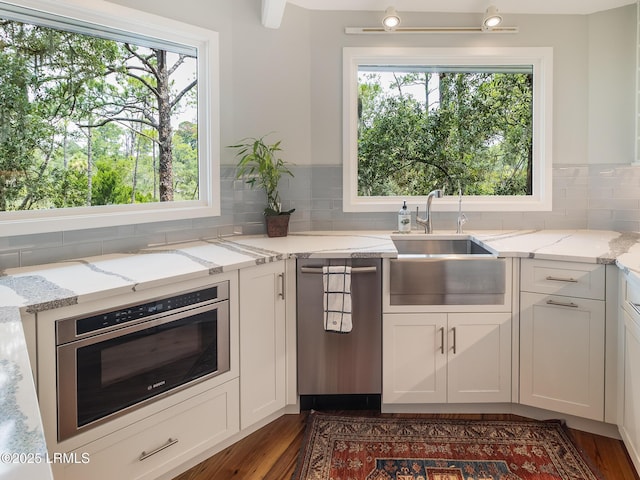 2065 Deer Island Rd, Hilton Head Island, SC 29928 - kitchen featuring appliances with stainless steel finishes, plenty of natural light, white cabinets, and tasteful backsplash