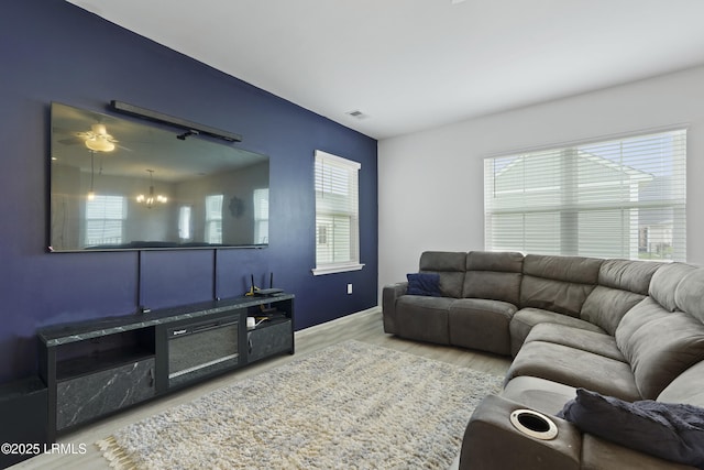 48 Garden Row Dr S, Hardeeville, SC 29927 - living room featuring wood finished floors, healthy amount of natural light, and a chandelier