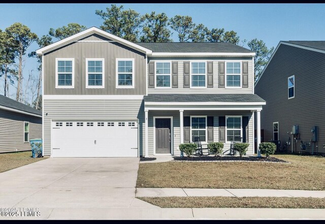 view of front of property featuring a porch, a garage, and a front yard