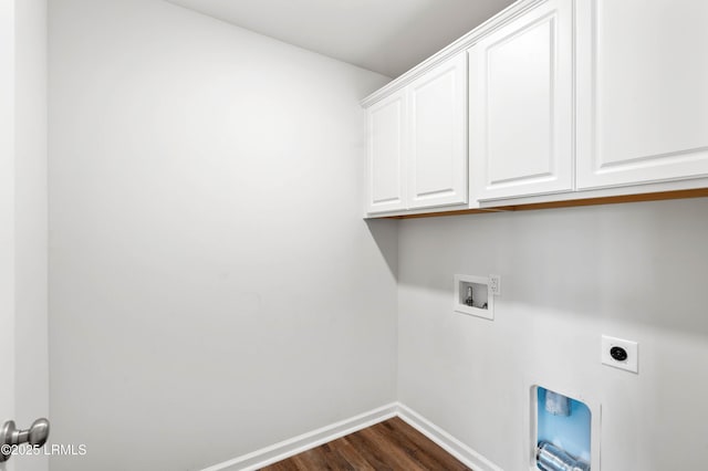 clothes washing area with washer hookup, cabinet space, dark wood-type flooring, electric dryer hookup, and baseboards