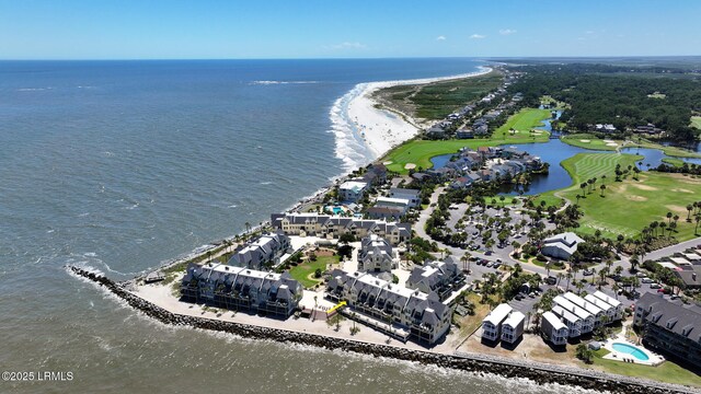 drone / aerial view with a water view and golf course view