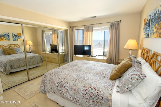 tiled bedroom featuring a closet