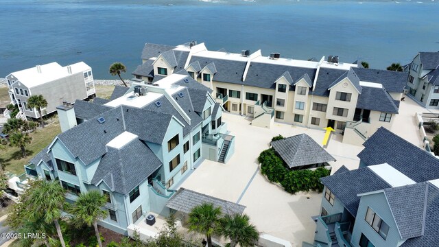 drone / aerial view featuring a water view and a residential view