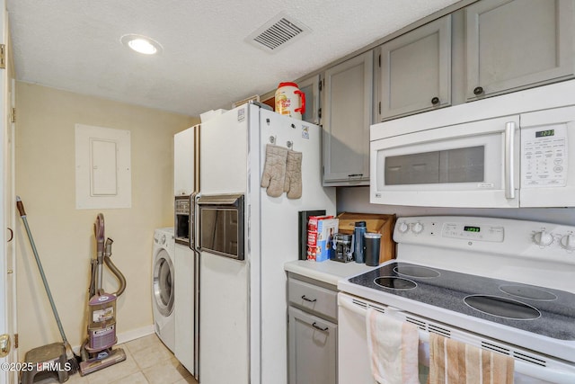 70 Paddle Boat Ln Unit 207, Hilton Head Island, SC 29928 - kitchen featuring white appliances, gray cabinetry, electric panel, light tile patterned flooring, and light countertops