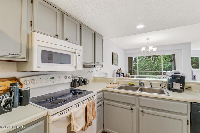 70 Paddle Boat Ln Unit 207, Hilton Head Island, SC 29928 - kitchen featuring white appliances, a chandelier, light countertops, recessed lighting, and a textured ceiling