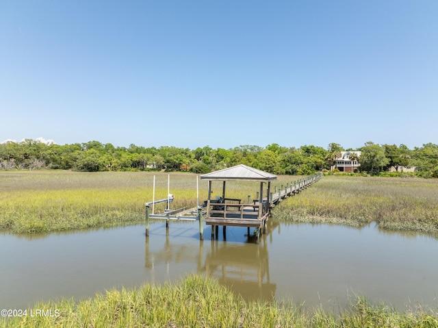 dock area with a rural view and a water view