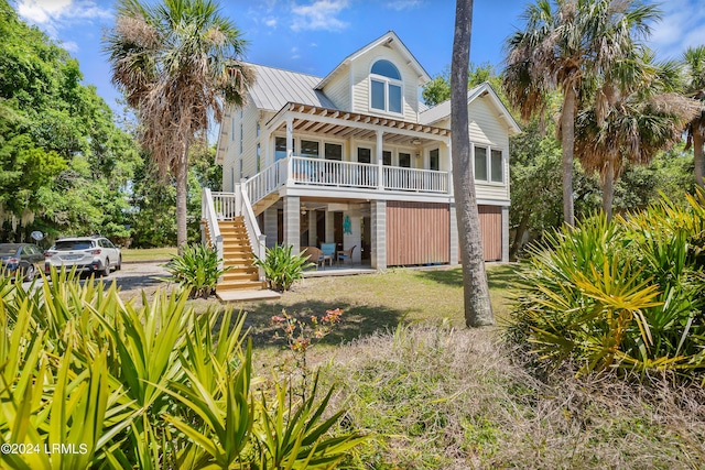 back of property featuring a pergola and covered porch