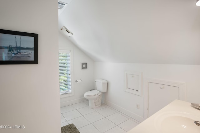 bathroom with tile patterned floors, toilet, vaulted ceiling, and vanity