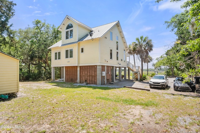 rear view of house with a yard