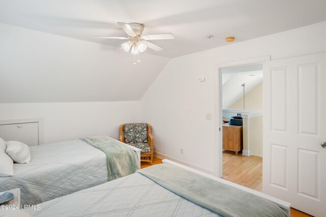 bedroom with lofted ceiling, ceiling fan, and light hardwood / wood-style flooring