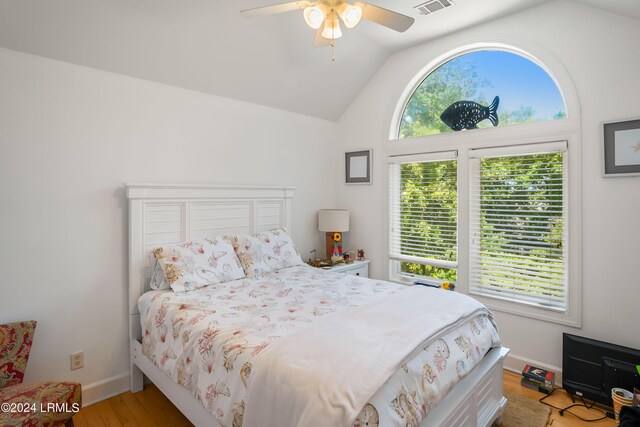 bedroom with ceiling fan, lofted ceiling, and light hardwood / wood-style flooring