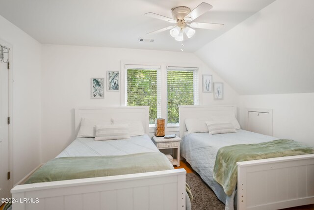 bedroom with hardwood / wood-style flooring, ceiling fan, and lofted ceiling