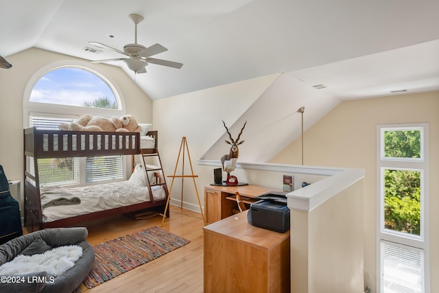 bedroom with lofted ceiling, ceiling fan, and light wood-type flooring