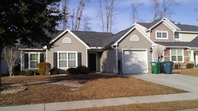 view of front of property with a garage and concrete driveway