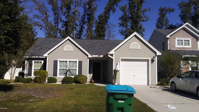 view of front of home with a garage, driveway, and a front yard