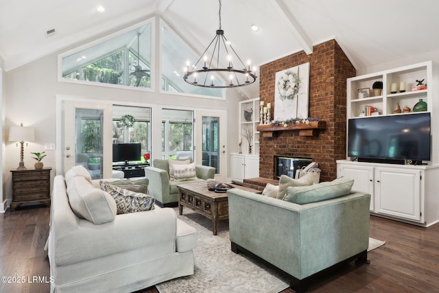 30 Longwood Dr, Okatie, SC 29909 - living room featuring a chandelier, dark wood-style flooring, beamed ceiling, a brick fireplace, and high vaulted ceiling