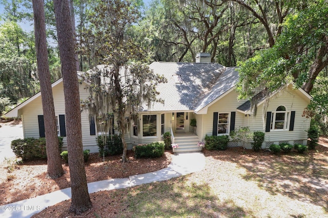 30 Longwood Dr, Okatie, SC 29909 - view of front of home featuring a chimney, a shingled roof, and a porch