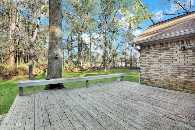 wooden deck featuring a yard