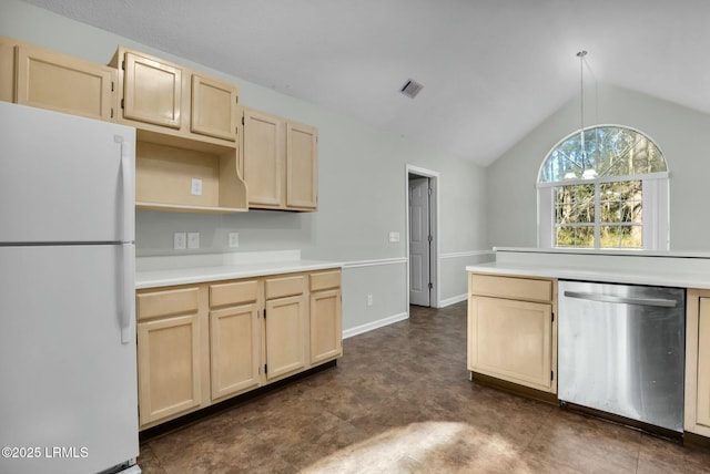 kitchen with freestanding refrigerator, light countertops, vaulted ceiling, and stainless steel dishwasher