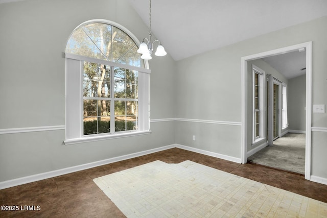 unfurnished dining area featuring lofted ceiling, dark tile patterned floors, baseboards, and a notable chandelier