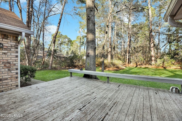 wooden terrace featuring a yard