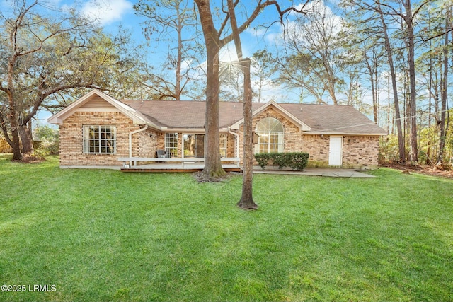 single story home with a patio area, a front yard, and brick siding