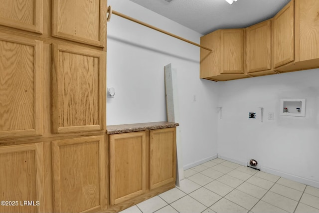 laundry room featuring light tile patterned floors, hookup for a washing machine, cabinet space, hookup for an electric dryer, and baseboards